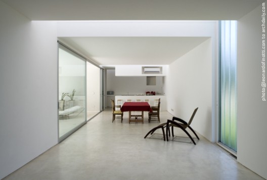 View of the dinning room, kitchen in background and patio on lef