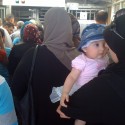Kalandia Checkpoint. The First New Gate To Jerusalem in 466 Years. (1) Kalandia Checkpoint. The First New Gate To Jerusalem in 466 Years. (1) Mom and infant passing through Kalandia Checkpoint © Harris Silver