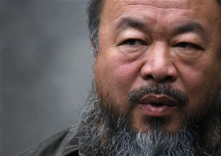 Dissident Chinese artist Ai Weiwei answers a question during an interview at his studio in Beijing
