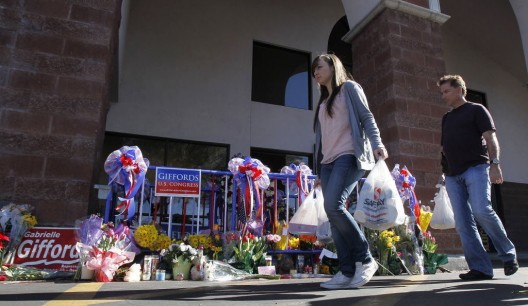 Shoppers at the Safeway in Tucson where the 2011 shooting took place. A small plaque memorializing the event was placed out front. Image Courtesy of AP Photo via LehighValleyLive.com