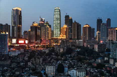 The old buildings under these high-rises in Chongqing have been marked for demolition. © Justin Jin for The New York Times