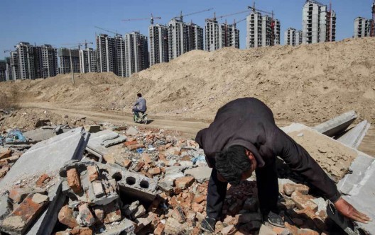 Li Rui, 60, scavenging his former village for building materials in Liaocheng. © Justin Jin for The New York Times