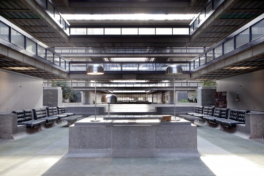 The lobby of Bell Labs in Holmdel, New Jersey, is part of a five-story, quarter-mile-long atrium. Most of the original built-ins, by Eero Saarinen, are in remarkably good shape.. Image © Rob Dobi