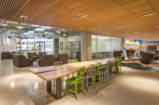 Zappos is one of the biggest companies to function as a ‘holocracy’ (without a fixed staff hierarchy). Their Las Vegas headquarters utilizes communal furniture to increase team-based collaboration (according to Business Insider, ‘desks are linked but can be easily disconnected or moved, the walls are movable as well. So if a team needs to work a different way, or a new product team is formed, the space can be changed, and changed again until it works’). Image Courtesy of Zappos, via OfficeSnapshots.com