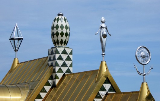Grayson Perry's sculptures adorning the eaves of A House For Essex. Image © FAT/ Living Architecture